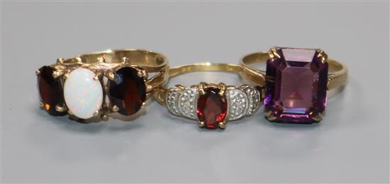 Three assorted 9ct gold and gem set dress rings,.